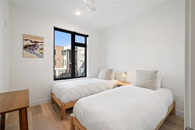 Bedroom with hardwood / wood-style flooring and ceiling fan | Image 16