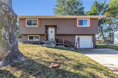 Bi-level home featuring a garage and a front lawn | Image 3