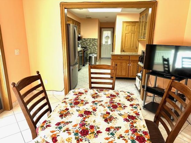 Dining space with light tile patterned flooring | Image 17