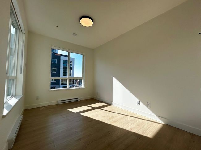 Unfurnished room featuring baseboard heating, baseboards, wood finished floors, and a baseboard heating unit | Image 8