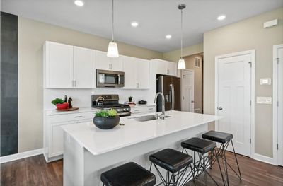 (Photo of decorated model, actual home's finishes will vary) Imagine entertaining in this stunning kitchen! | Image 1