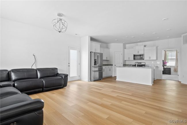 Living area with an inviting chandelier, recessed lighting, light wood-type flooring, and visible vents | Image 5