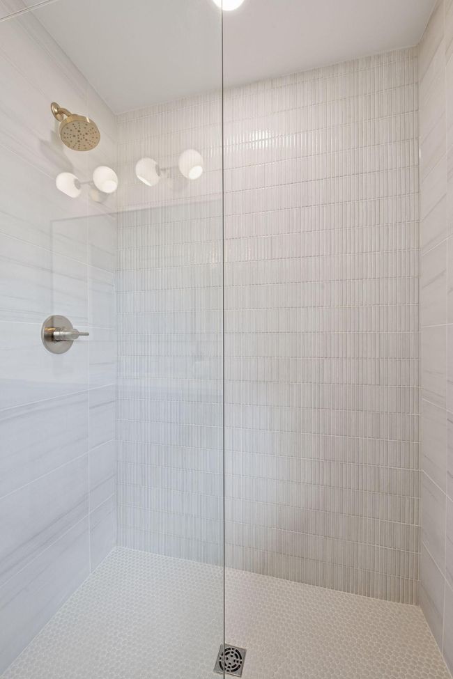Beautiful tile in the main level shower. | Image 17