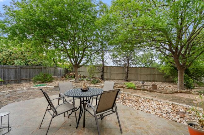 View of patio featuring a fenced backyard and outdoor dining area | Image 35