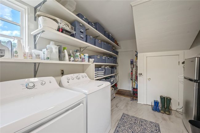 Laundry room featuring light marble finish floors and washer and dryer | Image 40