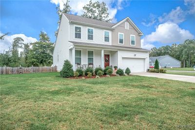 View of front of house featuring a front lawn and a garage | Image 2