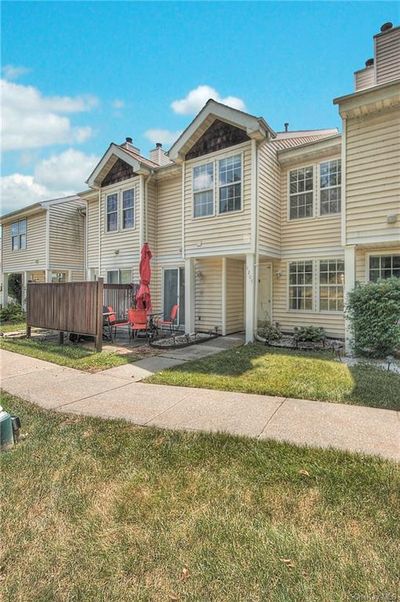 Townhome / multi-family property with a front yard | Image 2