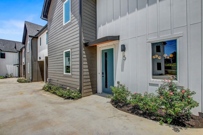 Doorway to property with board and batten siding and a patio area | Image 28