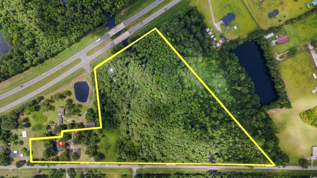 Aerial view of property and surrounding area with property boundaries highlighted and a nearby body of water | Image 40