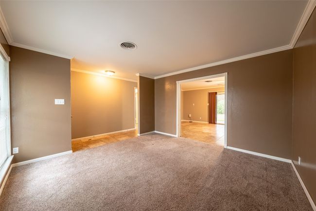 Spare room featuring crown molding and light colored carpet | Image 15