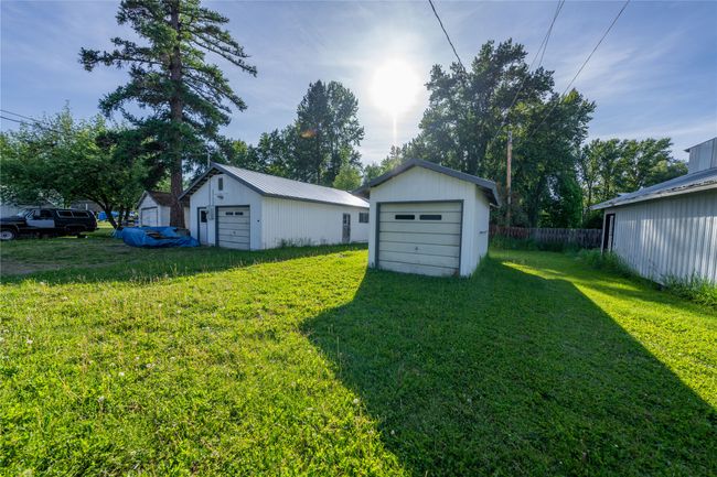 View of yard featuring a garage and an outbuilding | Image 34