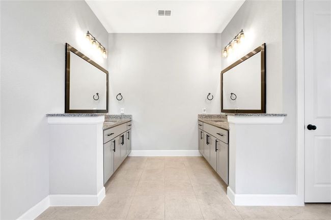 Two separate vanity sinks with custom framed mirrors and upgraded hardware | Image 29