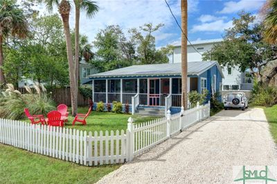 Front yard with picket fence and gravel driveway | Image 1