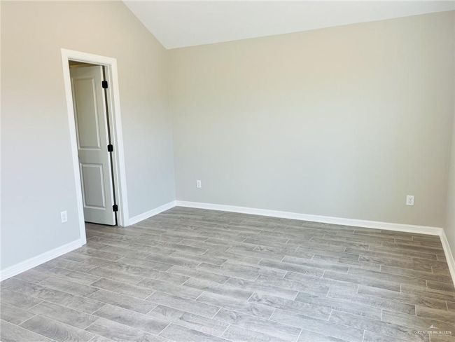 Unfurnished room with vaulted ceiling and light wood-type flooring | Image 5