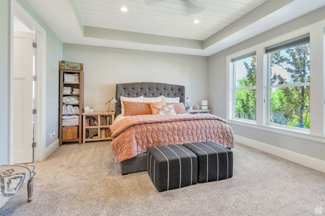 Bedroom featuring carpet flooring, a tray ceiling, and recessed lighting | Image 29