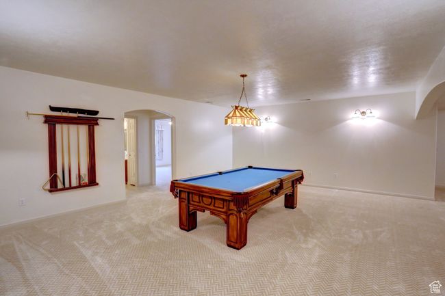 Game room with arched walkways, pool table, and light carpet | Image 30