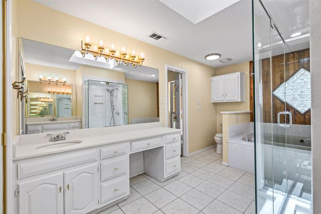 Full bathroom featuring vanity, a stall shower, and tile patterned floors | Image 21