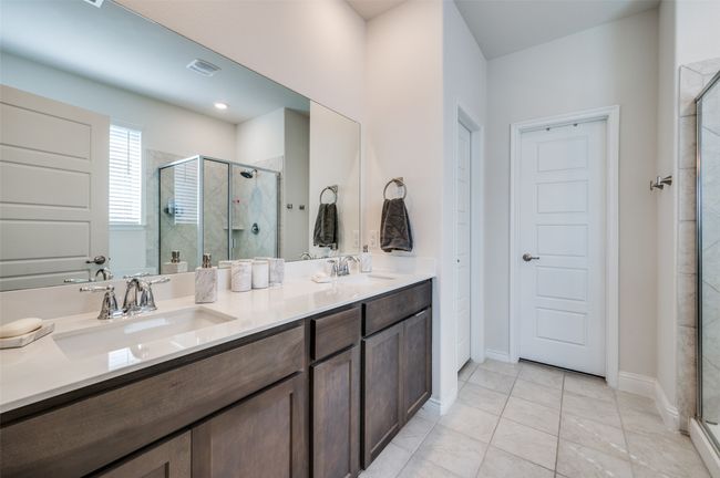 Bathroom featuring visible vents, a sink, and a stall shower | Image 12