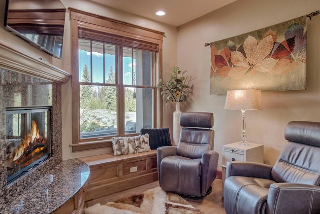 Enjoy your morning cup of coffee by the fire in the sitting room just off the kitchen. | Image 11