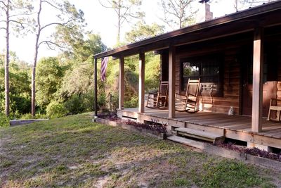 Classic front porch facing wooded front yard | Image 2