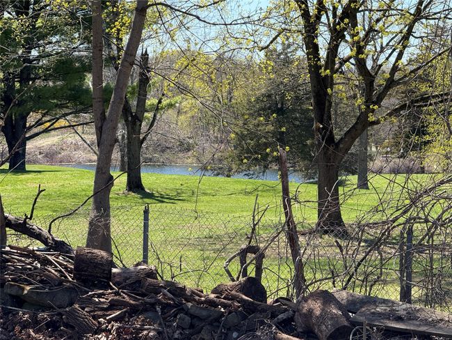 View of Golfwith a water view and fence | Image 25