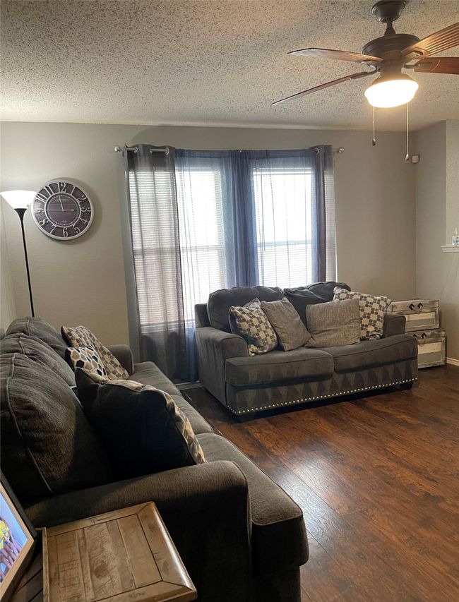 Living room, wood-style flooring and ceiling fan | Image 5