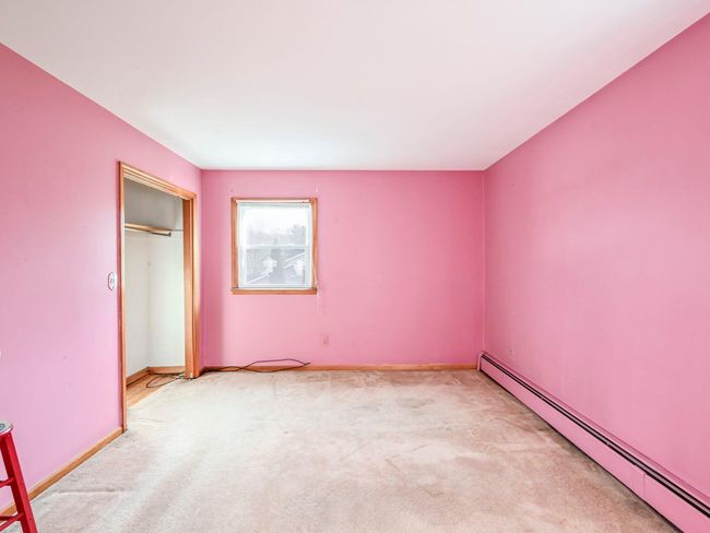Unfurnished bedroom featuring a closet, light carpet, and a baseboard radiator | Image 12