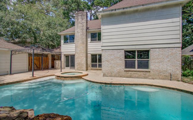 Hot tub and pool features a jumping rock. | Image 7