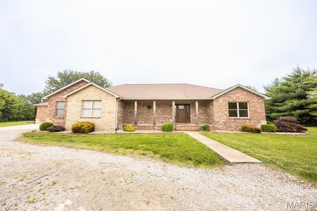 Ranch-style house featuring brick siding, a front lawn, covered porch, and roof with shingles | Image 7