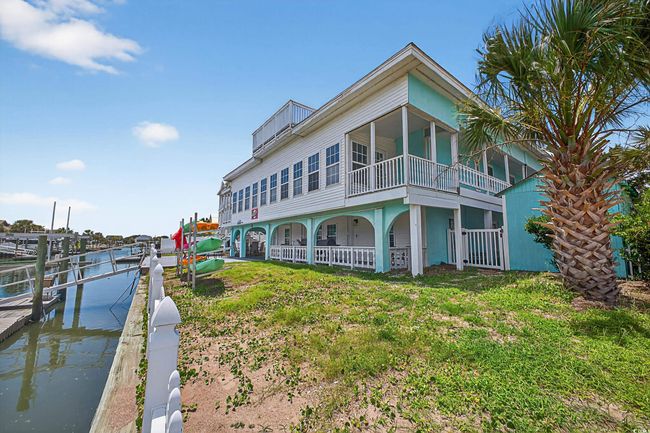 Back of house featuring a balcony and a water view | Image 40