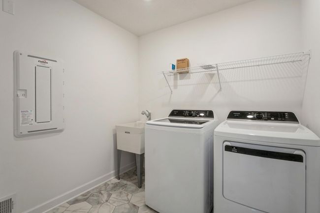 Photo is of the actual home. Upper level laundry! | Image 15