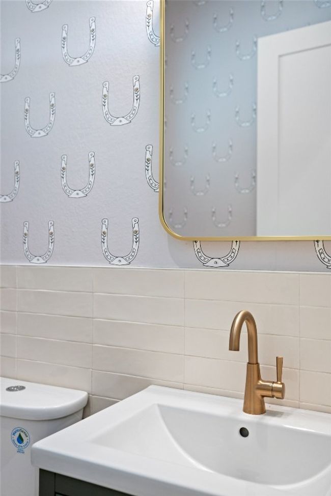 Bathroom featuring tile walls, toilet, and vanity | Image 8