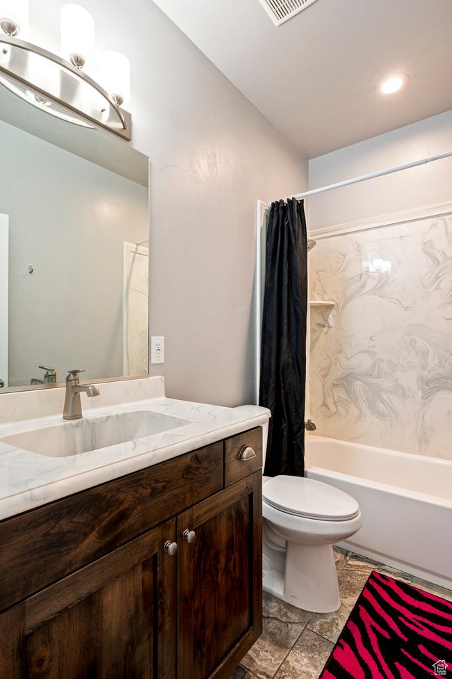 Bathroom with vanity, shower / bath combination with curtain, and toilet | Image 41