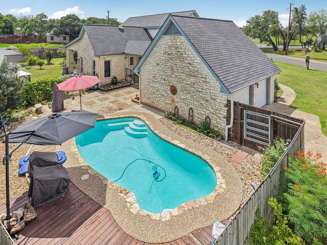 View of pool featuring a fenced backyard, a patio area, and grilling area | Image 33