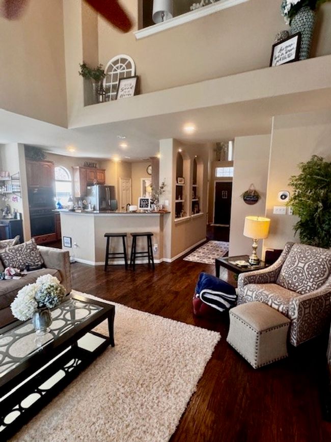 Living area with a high ceiling and dark wood-style flooring | Image 11