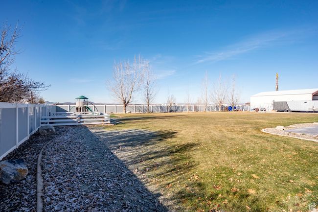 View of yard featuring a fenced backyard and playground community | Image 51