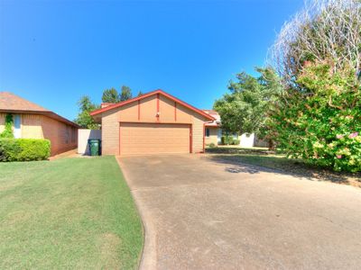 View of front of property with a front yard and a garage | Image 1