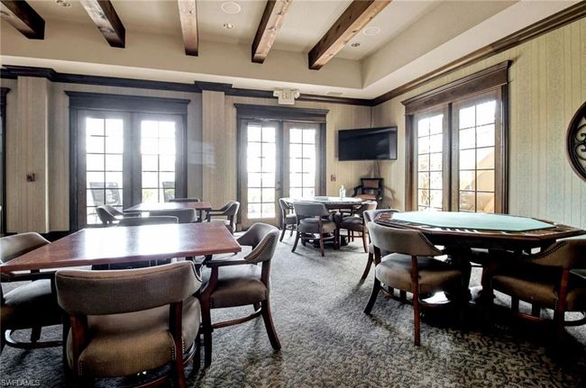 Carpeted dining room with french doors, plenty of natural light, beamed ceiling, and wallpapered walls | Image 44