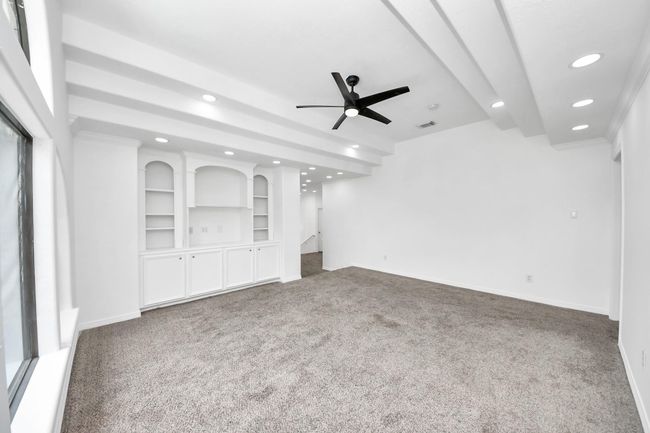 Gameroom with built-in drawers and beautiful tray ceiling | Image 30