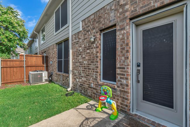 Doorway to property featuring brick siding | Image 26