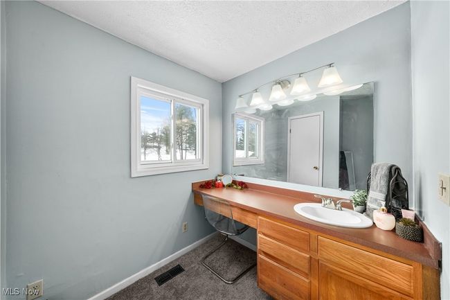 Bathroom with vanity and a textured ceiling | Image 17