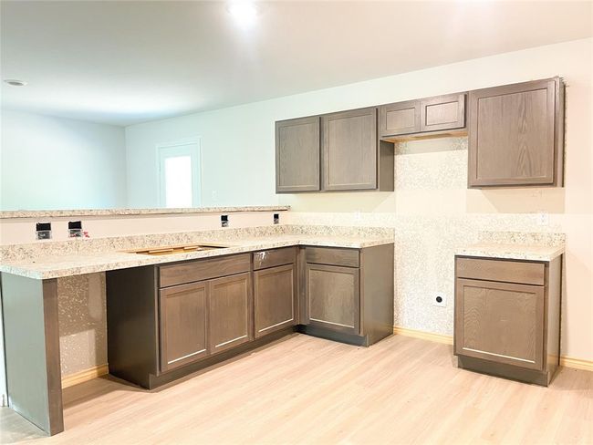 Modern kitchen featuring sleek cabinetry, spacious countertops, and ample natural light—perfect for cooking and entertaining. | Image 5