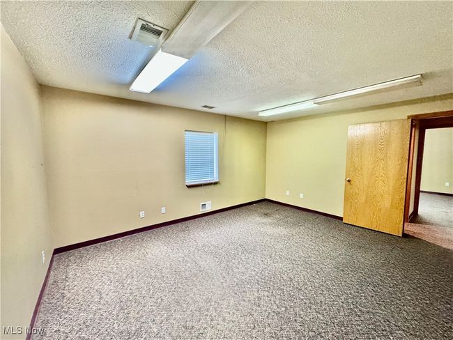 Spare room with carpet floors and a textured ceiling | Image 16