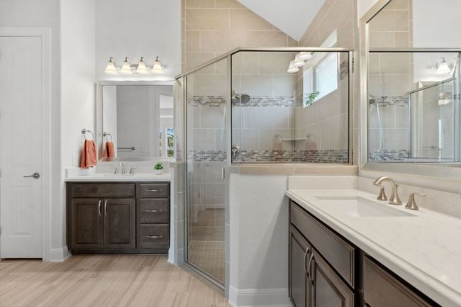 Full bath with a sink, two vanities, a shower stall, and vaulted ceiling | Image 23