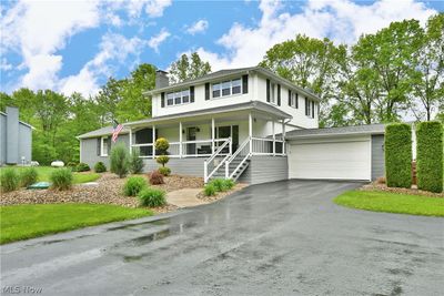 View of front of property with a garage and covered porch | Image 1