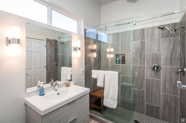 Bathroom with visible vents, a stall shower, and vanity | Image 22