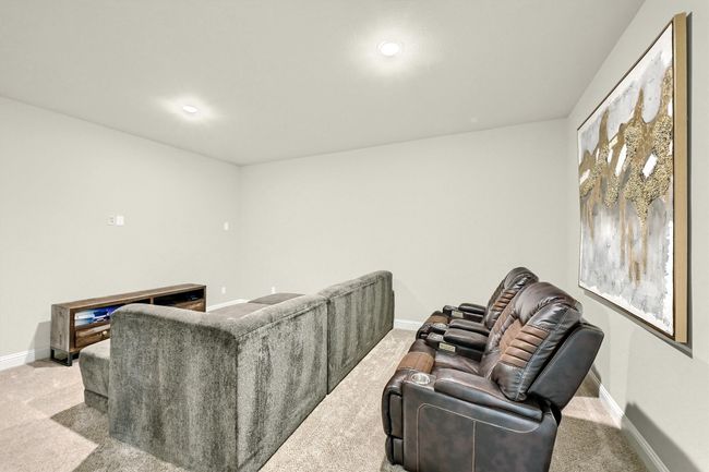 Carpeted living area featuring baseboards and recessed lighting | Image 28