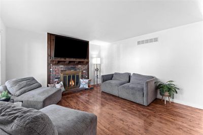 Living room featuring wood-type flooring and a fireplace | Image 3