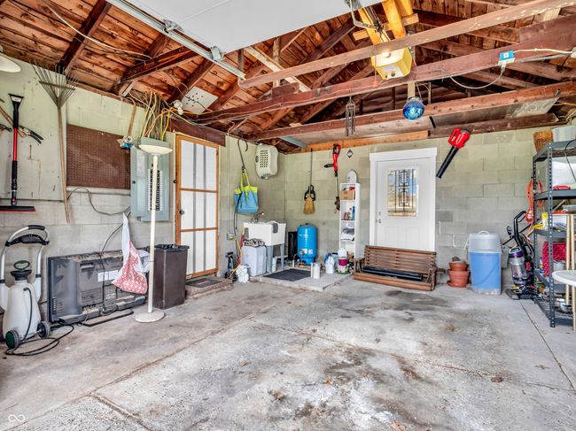 garage featuring concrete block wall and a sink | Image 30