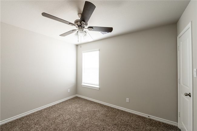 Unfurnished room featuring baseboards, carpet, and a ceiling fan | Image 15